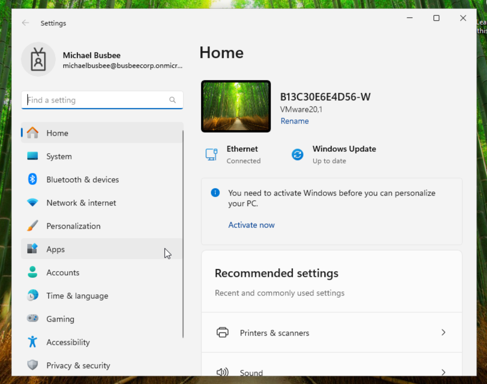 Windows settings showing corporate account and device name